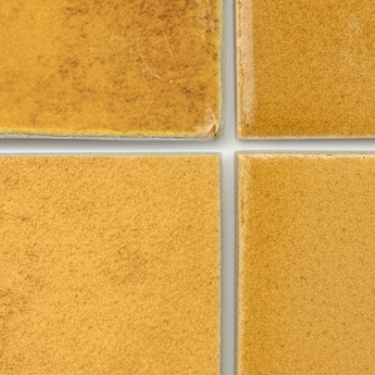 Warm amber-coloured ceramic tiles on neutral background