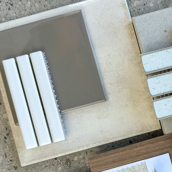 Cappuccino-tone tiles in a gloss finish in a flatlay as part of a design moodboard