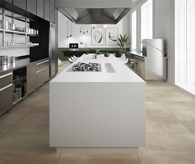 Non-slip commercial kitchen with tiled flooring rated P5 R12 for high slip resistance, featuring stainless steel benches and cooking equipment.