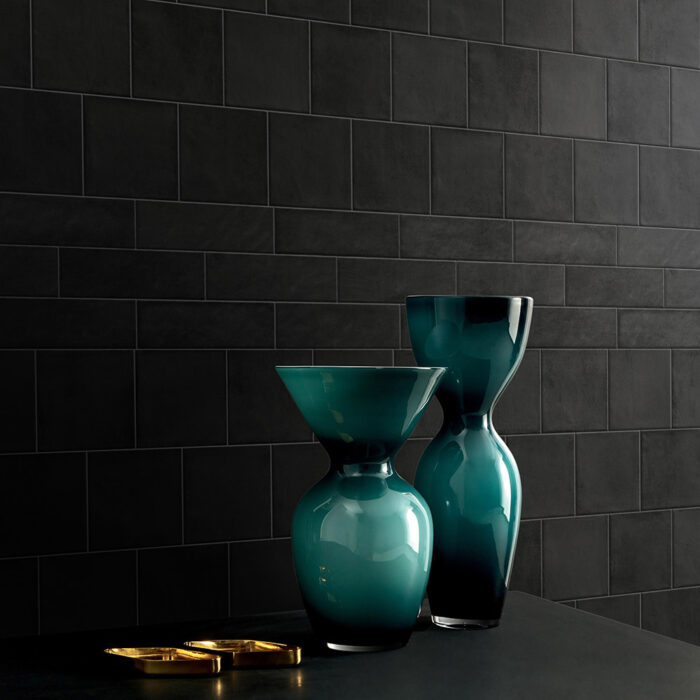 Black wall adorned with Solar Midnight matte tiles, creating a chic atmosphere.