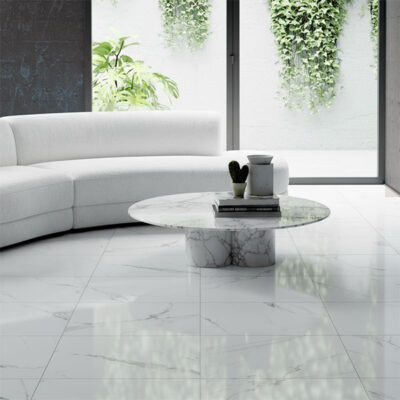 Close-up of glossy polished floor tiles reflecting light, showcasing a smooth, high-sheen finish.