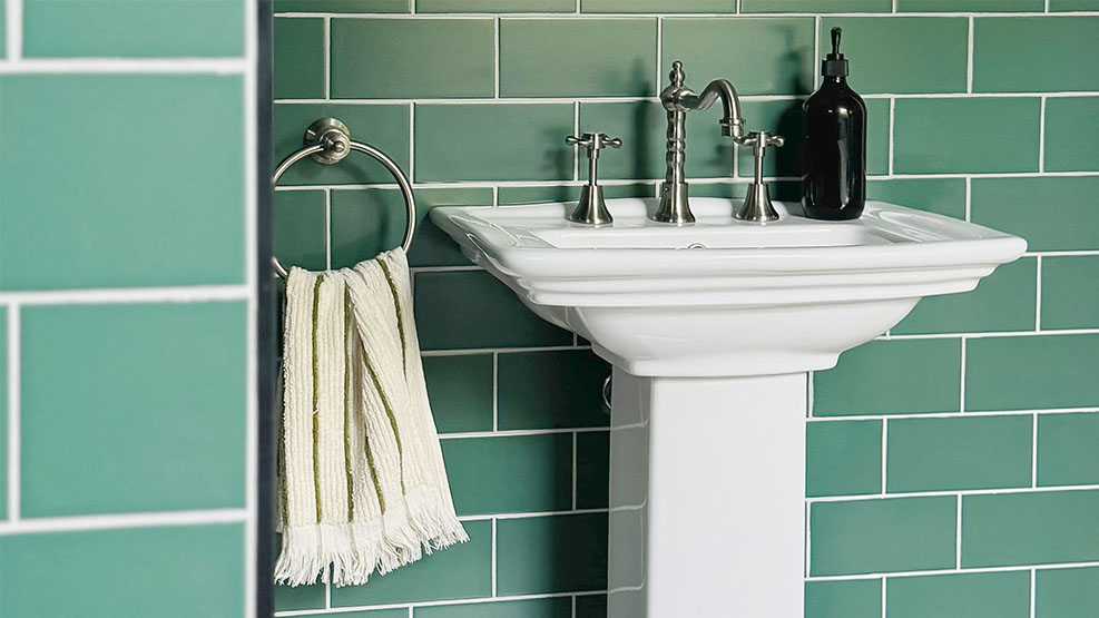 Contemporary bathroom featuring green wall tiles and natural interior styling