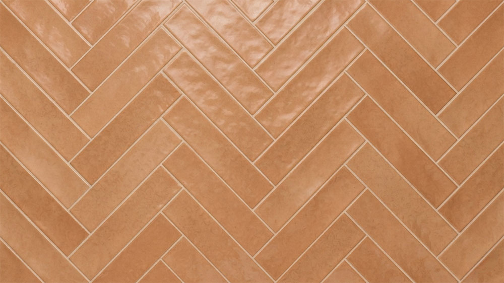 Herringbone tile pattern using rectangular tiles arranged in an interlocking zigzag layout for visual movement.