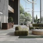 Spacious hotel lobby setting featuring floor tiles rated P1, decorative lighting, and seating area.