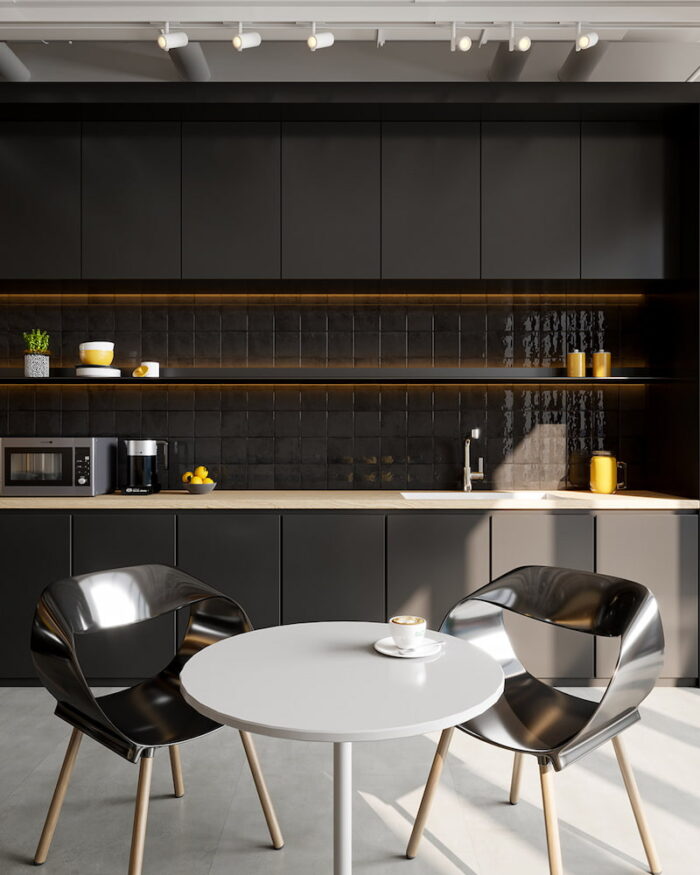 Stylish kitchen with black cabinets and a white table, beautifully displaying the contemporary Solar Midnight tiled aesthetic.