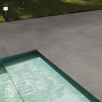 Outdoor swimming pool surround with textured P4-rated tiles providing grip in wet conditions.