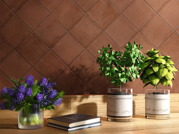 A charming table with three flower vases and books, beautifully placed on diamond-patterned Solar Brick matt tiles.