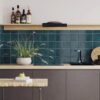 A charming kitchen adorned with blue tiles and a table, complemented by a contemporary Solar Pacific Gloss splashback.