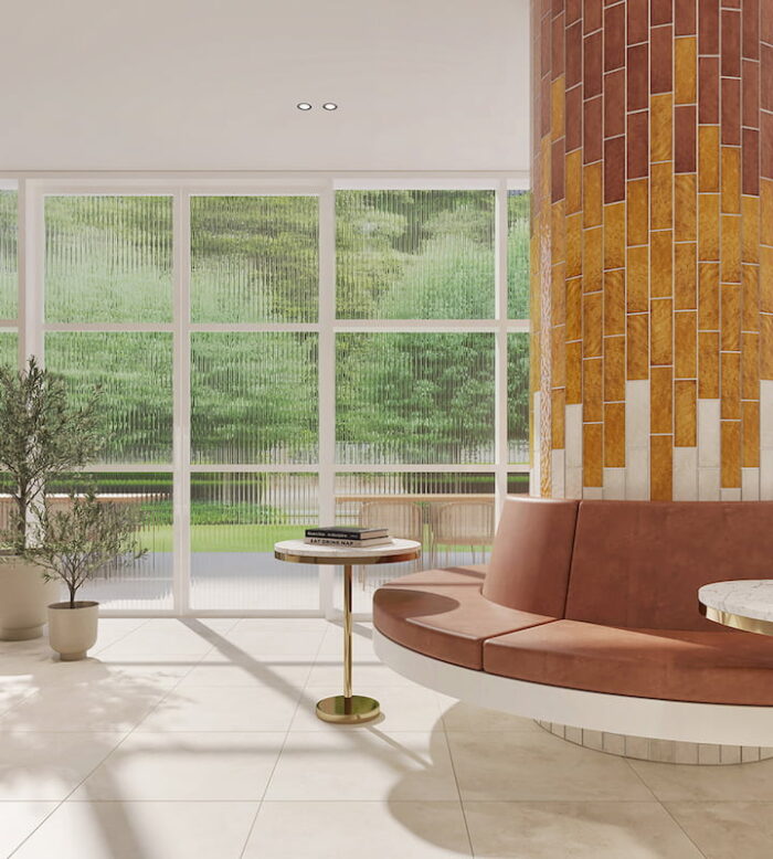 A stylish hotel lobby featuring a tiled column with a warm colour palette of Solar Pearl, Brick, and Amber.